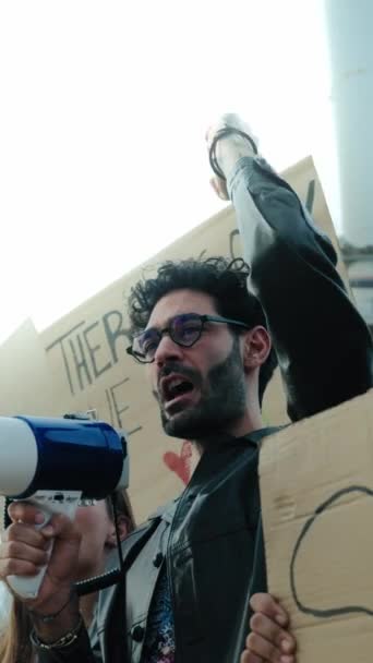 垂直的男人用扩音器大喊抗议社区对地球的污染 群策群力反对全球暖化 高举气候变化横幅 — 图库视频影像
