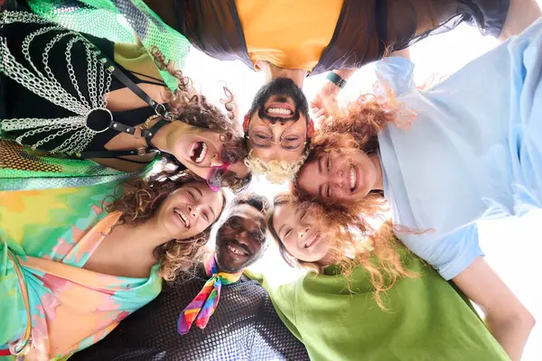 A group of friends are happily sharing smiles and creating art together in a circle, enjoying a leisure event filled with fun and laughter. LGBT people united and supportive of the community
