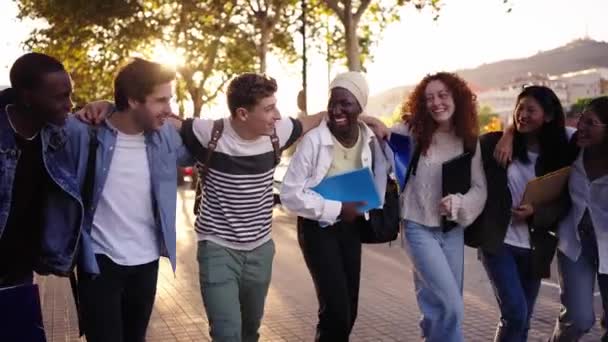 多种族的年轻快乐的学生在户外散步和聊天 不同的大学生朋友 课后背着背包和书本在校园公园里散步 — 图库视频影像