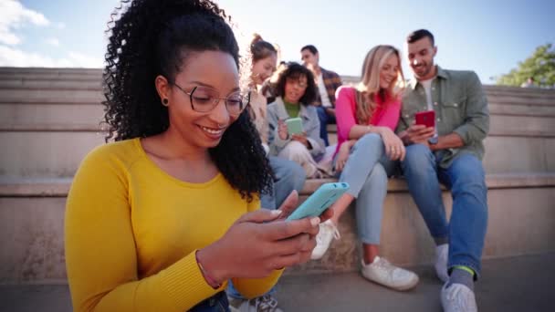 Smiling Latina Woman Using Smart Phone Sitting Bleachers Outdoor Friends — Stock Video