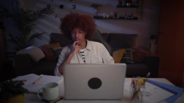 İç işlerinde bilgisayar kullanmadan önce düşünen Afro-Amerikalı bir adam. Afro girişimci erkek yeni dijital e-öğrenim projesi geliştirmeye odaklanıyor. Gece genç nesil z çevrimiçi