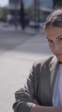 Dikey. Kafkasyalı genç bir iş kadını ciddi bir kamera karşısında duruyor. Kendine güvenen kadın resmi kıyafetleri ofis dışında poz veriyor. Resmi personel güzel, güçlü insanlar geçmişi bulanıklaştırdı