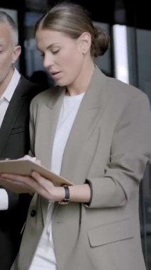 Dikey. Taşınırken çeşitli iş adamları ofis koridorunda hızla yürüyordu. Resmi profesyonel çalışanların çalıştığı bir merkez. Şirket ve işçiler lobi ve koridorda ilerliyor.