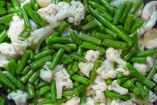 Mixed cauliflower and green beans. Close-up, for background or screensaver