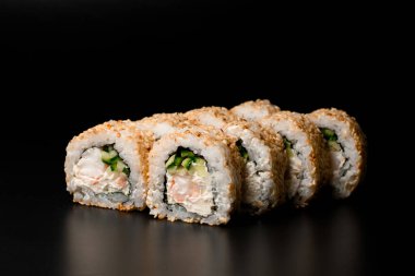 Sushi rolls California with crab meat, avocado, cucumber and cream cheese at dark background. Japanese food. Sushi menu.