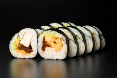 Sushi rolls with smoked eel, avocado, cream cheese and unagi sauce. Traditional japanese maki unagi roll. Sushi menu.