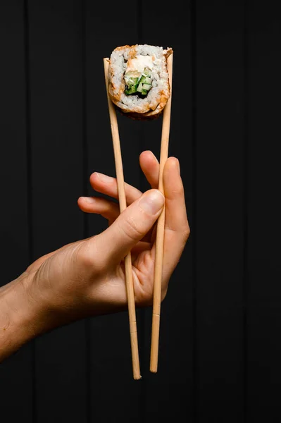 Hand Holds Philadelphia Sushi Roll Smoked Eel Cucumber Avocado Cream — Stok fotoğraf