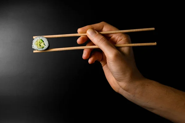 Female Hand Gently Holds One Classic Vegetarian Kappa Maki Sushi — Stok fotoğraf