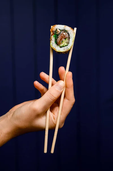 Side View One Tasty Philadelphia Roll Hand Holding Bamboo Chopsticks — 图库照片