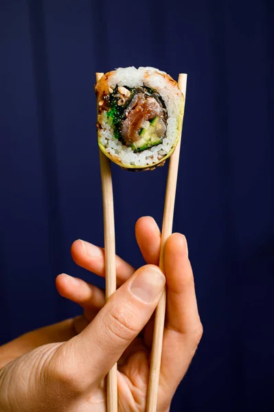 Close Side View One Tasty Philadelphia Roll Hand Holding Wooden — Stok fotoğraf