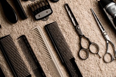 top view on table with professional scissors, combs, hair brushes and hair clips, trimmer. Barbershop. Cropped photo