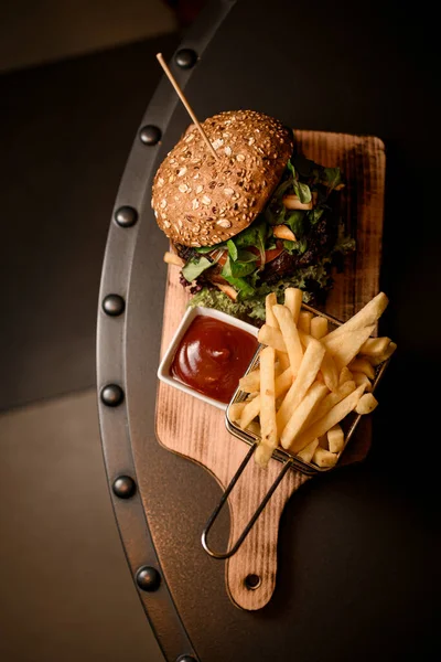 stock image great top view on big tasty double burger and french fries and ketchup on the wooden board on table