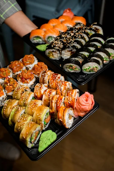 Waiters Hands Holds Two Calves Large Sushi Roll Sets Eel — Stock Photo, Image