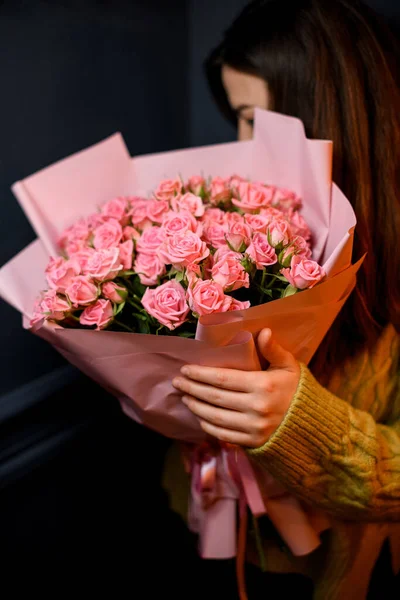 Młoda Ciemnowłosa Kobieta Kwiaciarnia Gospodarstwa Rękach Duży Bukiet Świeżych Róż — Zdjęcie stockowe