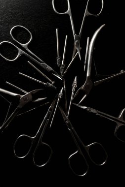 Siyah zemin, makas ve tırnak uçlarından izole edilmiş çelikten yapılmış manikür setleri.