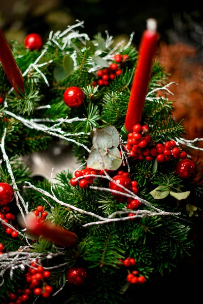 Christmas tree wreath decorated with red berries white twigs with red candles