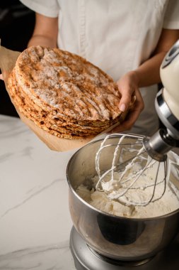 Protein kremi, marmelat, şekerli meyve, böğürtlen ve pudra şekeriyle süslemek için fırında kek hazırlıyorum.