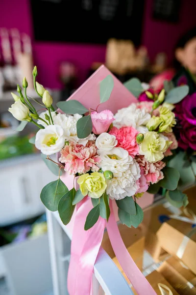 Beautiful arrangement of flowers in gift box at flower shop. Work of florist. Fresh cut flower. gift for women on a holiday. The concept of delivering flowers. floristry and flower shops.