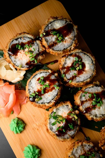 tantalizing sushi set with a touch of spice, breaded with green onions and served with a drizzle of soy sauce for added flavor.