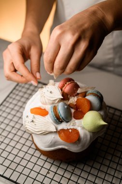 Fırıncıların elleri güzel Paskalya pastası beyaz renkli badem kurabiyeleri, kurutulmuş kayısılar ve çeşitli şekillerde kremalar.