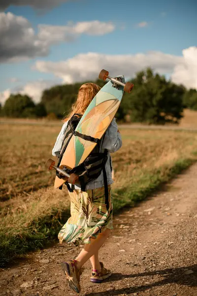 Strolling Road She Carries Longboard Her Back Embracing Journey Stock Photo