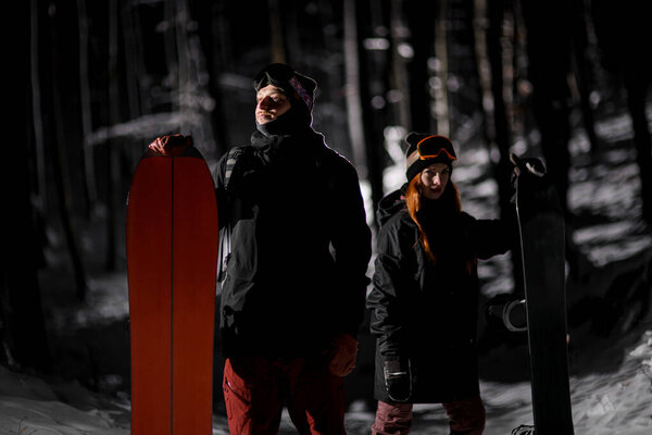 Man Woman Snowboarders Dark Ski Suits Standing Dark Winter Forest Stock Picture