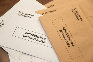 White and sepia envelopes for the elections to the congress and senate of the Spanish State that have in two official languages (Spanish and Catalan) the words Elections, deputies and senators