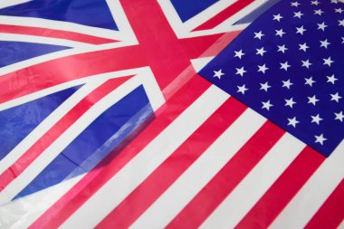 Closeup of two flags, the Union Jack of the United Kingdom and the American flag with the stars and stripes
