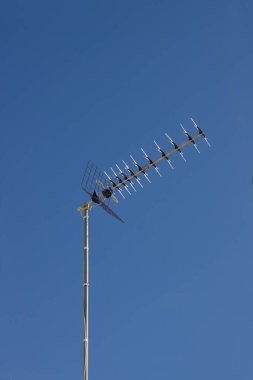 Image of a Yagi antenna or Yagi-Uda antenna used to capture digital terrestrial television broadcasts, DTT with the blue sky in the background and copy space