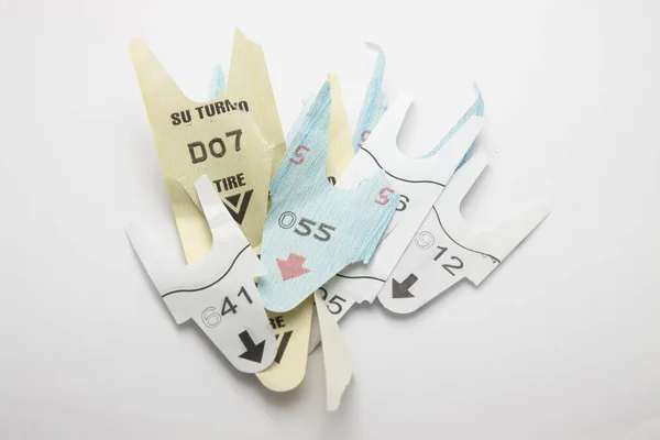 Image of a few various Your turn tickets for different services isolated on a white table