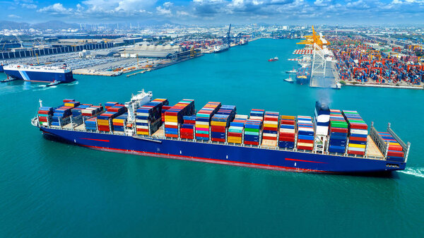 Aerial view of cargo ship carrying container running for export import near cargo yard port concept freight shipping.