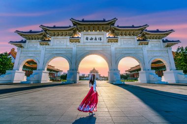 Asian woman in chinese dress traditional walking in Archway of Chiang Kai Shek Memorial Hall in Taipei, Taiwan. Translation: 