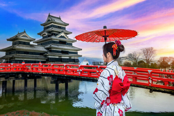 Asian woman wearing japanese traditional kimono at Matsumoto Castle, Nagano in Japan.