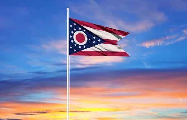 flag of Ohio on flagpoles and blue sky. Patriotic concept about state.