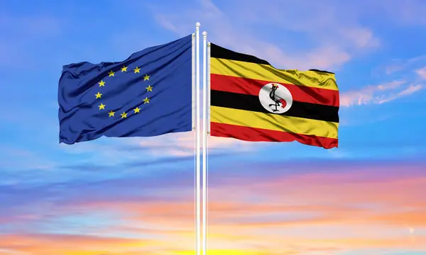 Unión Europea Uganda Dos Banderas Sobre Asta Bandera Cielo Azul Imagen De Stock