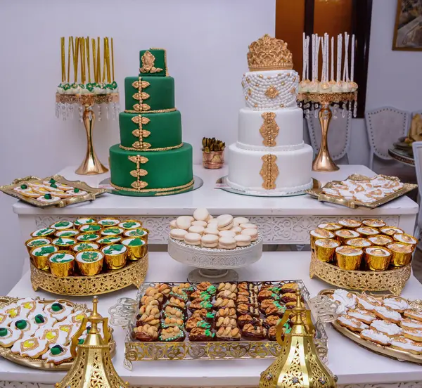 Stock image Two wedding cakes with a Moroccan theme on the festive table with plenty of snacks on the side