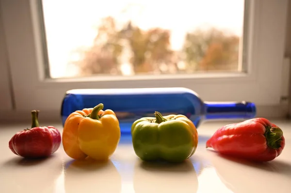 red and green bell peppers on table