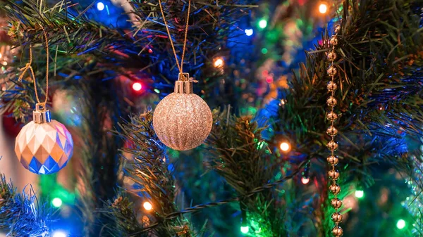 stock image Christmas tree ornaments hanging on tree. Christmas decorations concept with shiny lights and objects. Selective focus included