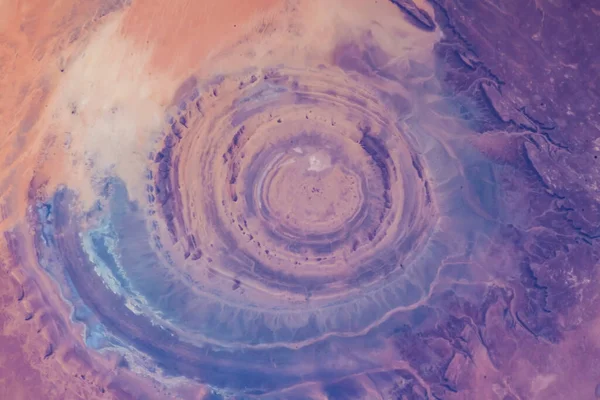 Eye of the Sahara in northwestern Mauritania Aerial view of Sahara desert. Natural abstract patterns and shapes in the nature. Colorful background. Elements of this image furnished by NASA.