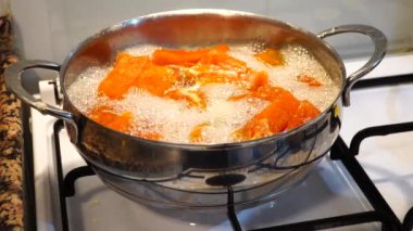 Pumpkin dessert making process. Pumpkin boiling in the pot. Traditional Turkish food pumpkin dessert