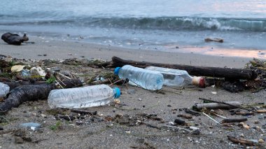 Plastic waste on beach. non-biodegradable waste on beach. Spilled garbage by the sea. Environmental pollution problem.