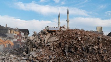 Earthquake damage in a city. Destroyed buildings after an earthquake. Collapsed buildings. Ruined city because of war. Airstrike damages a city. Urban transformation concept. Selective focus included