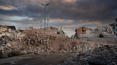 Earthquake damage in a city. Destroyed buildings after an earthquake. Collapsed buildings. Ruined city because of war. Airstrike damages a city. Urban transformation concept. Selective focus included