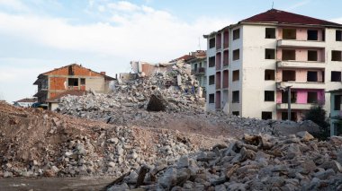 Earthquake damage in a city. Destroyed buildings after an earthquake. Collapsed buildings. Ruined city because of war. Airstrike damages a city. Urban transformation concept. Selective focus included