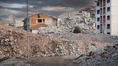 Earthquake damage in a city. Destroyed buildings after an earthquake. Collapsed buildings. Ruined city because of war. Airstrike damages a city. Urban transformation concept. Selective focus included