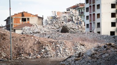 Earthquake damage in a city. Destroyed buildings after an earthquake. Collapsed buildings. Ruined city because of war. Airstrike damages a city. Urban transformation concept. Selective focus included