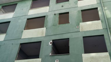 Urban transformation, the process of redevelopment and revitalization of urban areas. Excavators in construction site demolishing old buildings in Golcuk Kocaeli Turkey. Selective focus included