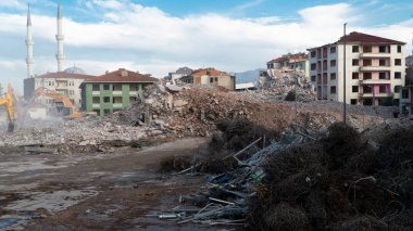 Urban transformation, the process of redevelopment and revitalization of urban areas. Excavators in construction site demolishing old buildings in Golcuk Kocaeli Turkey. Selective focus included