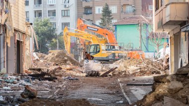 Urban transformation, the process of redevelopment and revitalization of urban areas. Excavators in construction site demolishing old buildings in Golcuk Kocaeli Turkey. Selective focus included