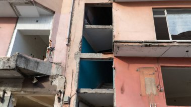 War damage in a city. Buildings damaged by an enemy aircraft missiles. Ruined city. Attack on civilian settlements. War crime. Selective focus included.